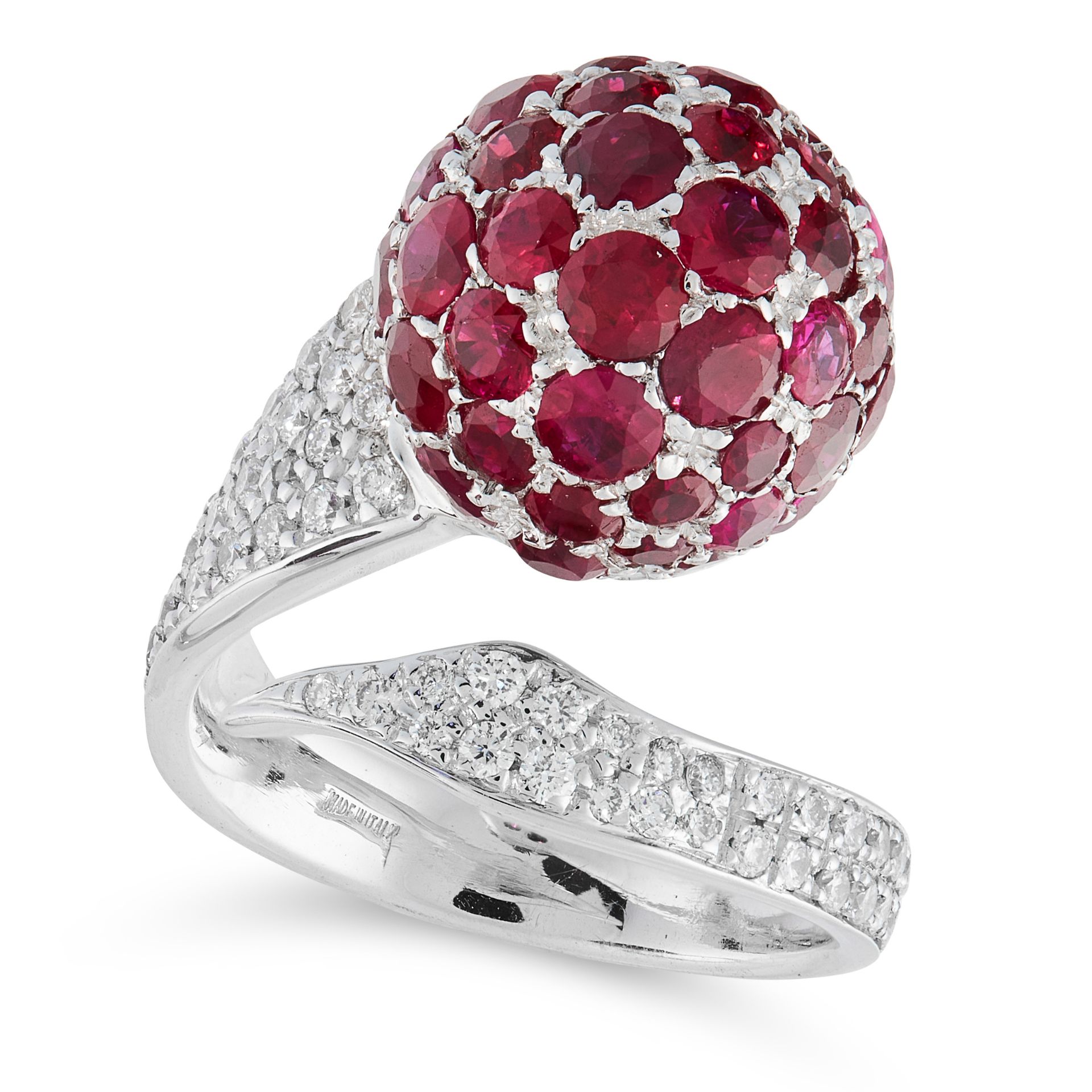 A RUBY AND DIAMOND DRESS RING in 18ct white gold, in cross over open band design, set with a sphere,