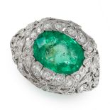 A COLOMBIAN EMERALD AND DIAMOND RING in platinum, set with an oval cut Colombian emerald, in open