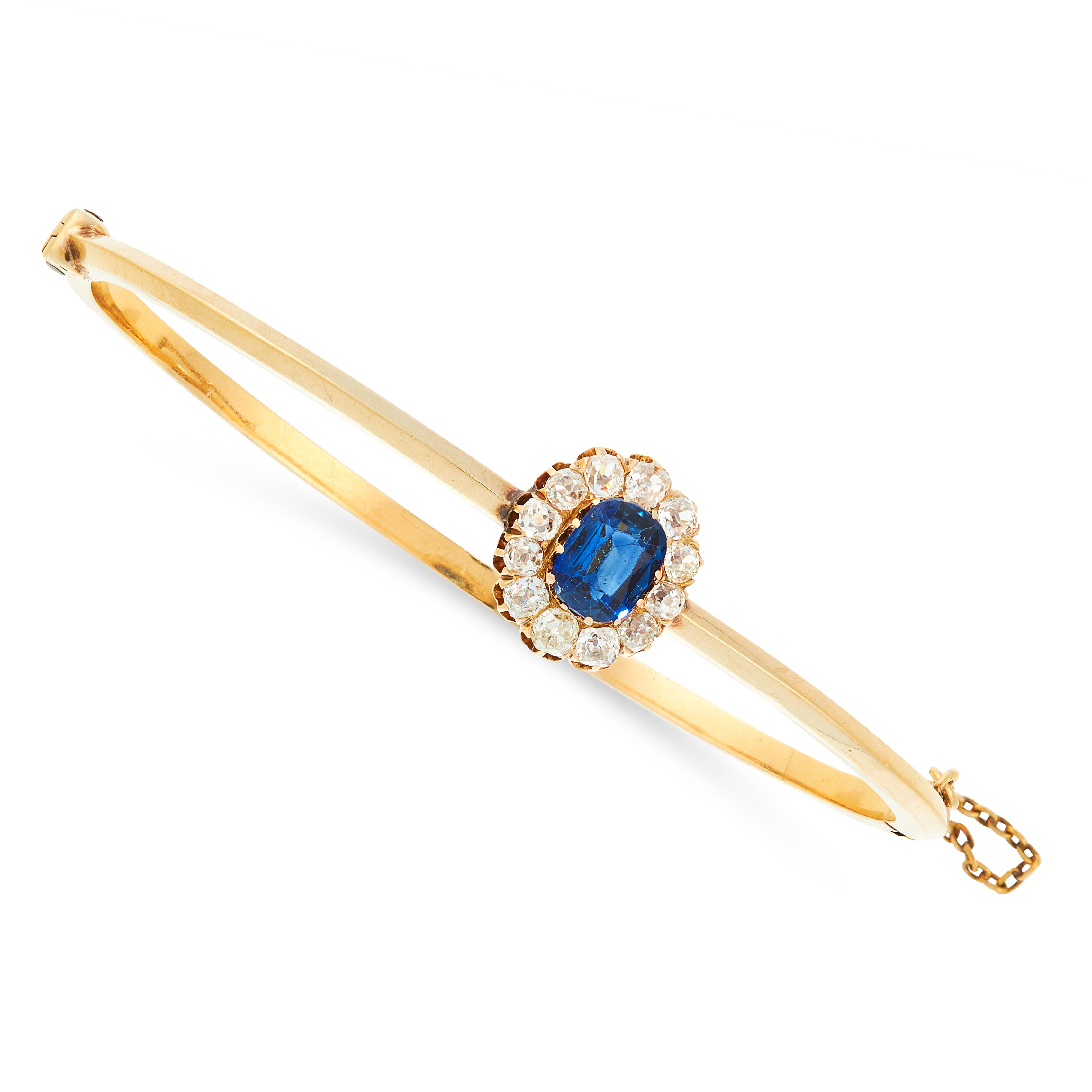 AN ANTIQUE SAPPHIRE AND DIAMOND BANGLE in high carat yellow gold, set with a cushion cut blue