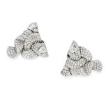 A PAIR OF RETRO DIAMOND CLIP BROOCHES formed of stylised scrolling ribbons, set with principal old