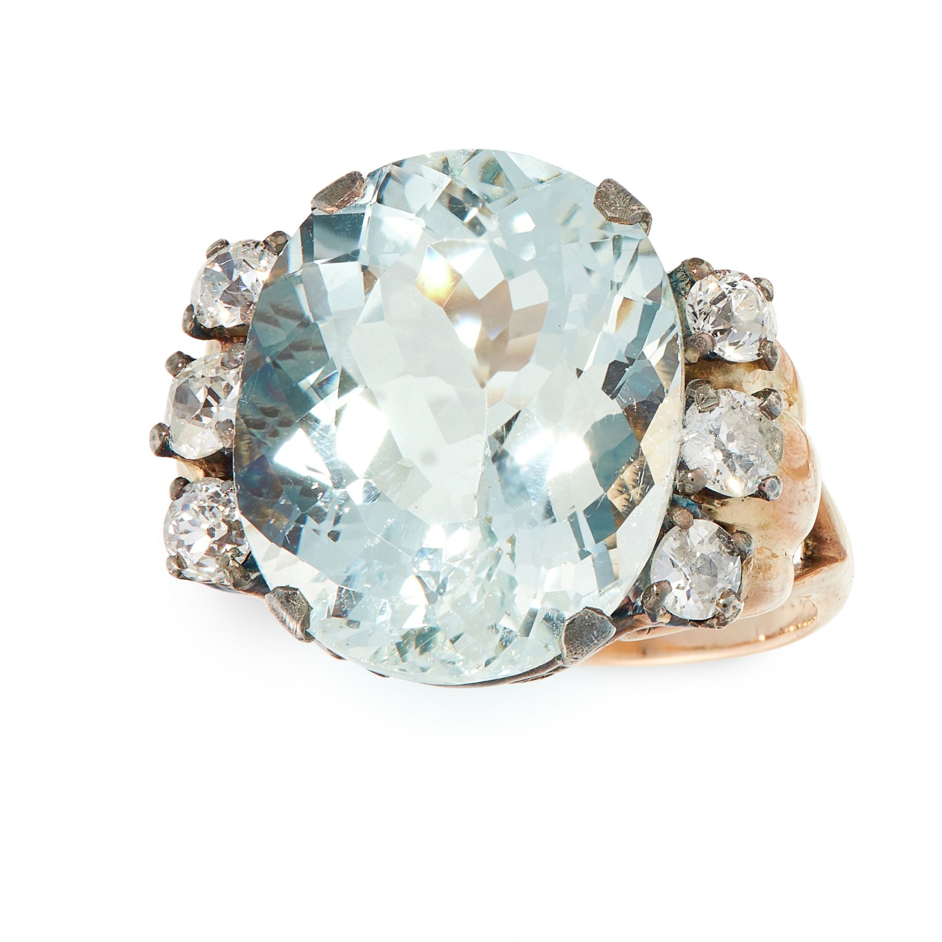 AN AQUAMARINE AND DIAMOND DRESS RING in yellow gold and silver, set with an oval cut aquamarine of