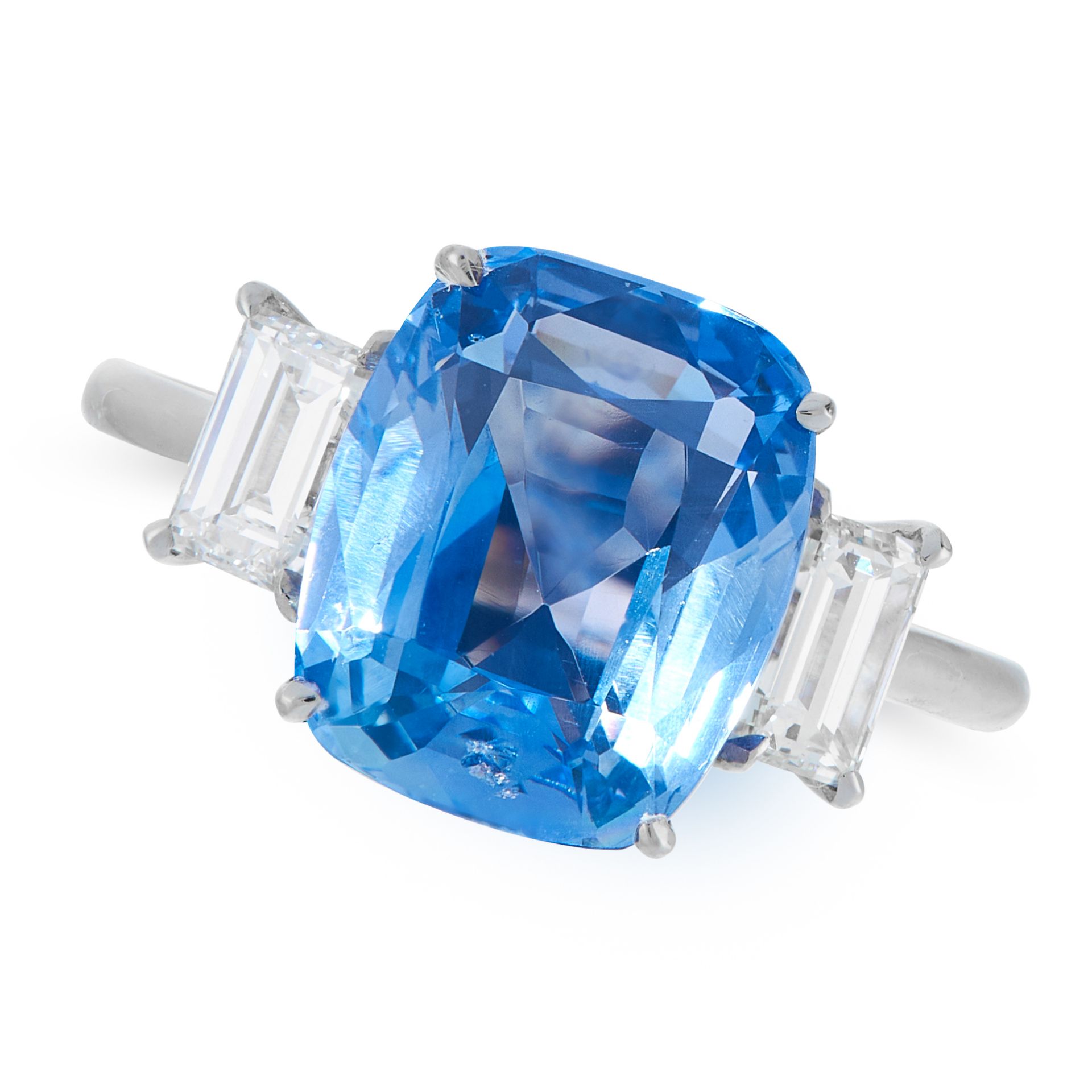 A CEYLON NO HEAT SAPPHIRE AND DIAMOND RING in platinum, set with a cushion cut blue sapphire of 5.12