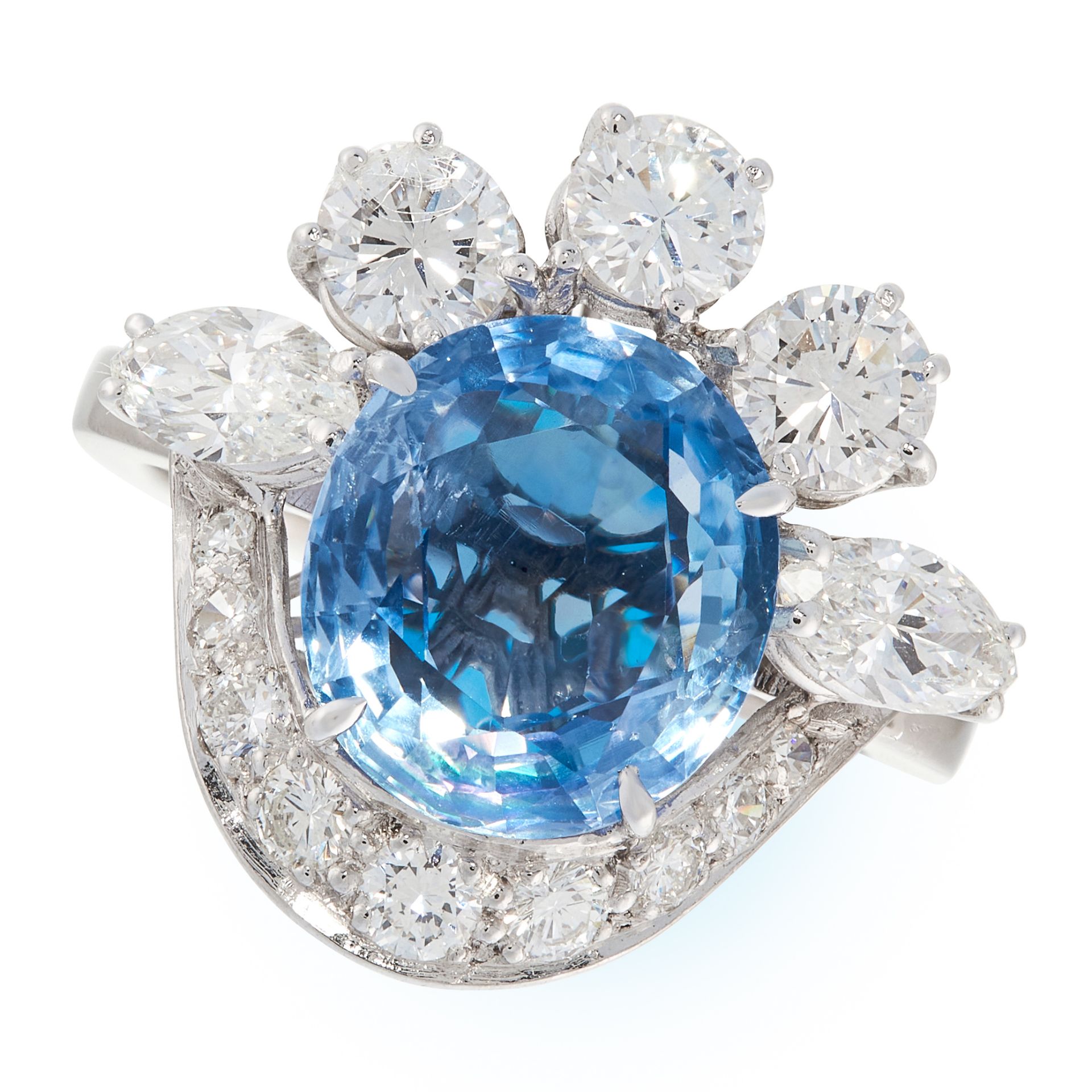 A CEYLON NO HEAT SAPPHIRE AND DIAMOND DRESS RING in 18ct white gold, set with an oval cut blue