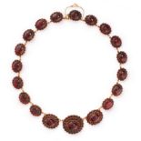 AN ANTIQUE GARNET RIVIERE NECKLACE, 19TH CENTURY in yellow gold, comprising a single row of nineteen