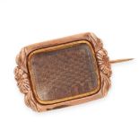 AN ANTIQUE HAIRWORK MOURNING LOCKET BROOCH, 19TH CENTURY in yellow gold, set with a glass covered