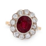 AN UNHEATED RUBY AND DIAMOND DRESS RING in 18ct yellow and white gold, set with a cushion cut ruby