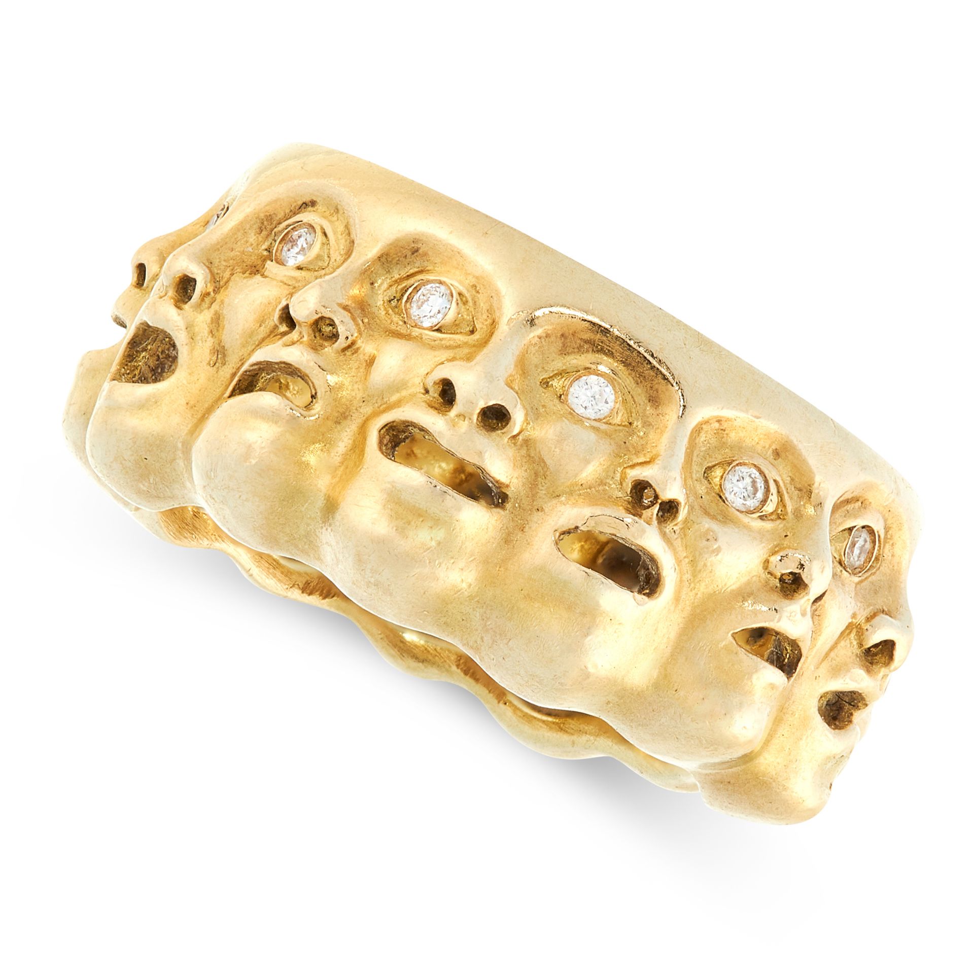 A VINTAGE DIAMOND DRESS RING in high carat yellow gold, formed of a row of theatrical mask faces set