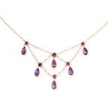 AN ANTIQUE AMETHYST AND PEARL FRINGE NECKLACE, CIRCA 1900 in yellow gold, set with pear cut and
