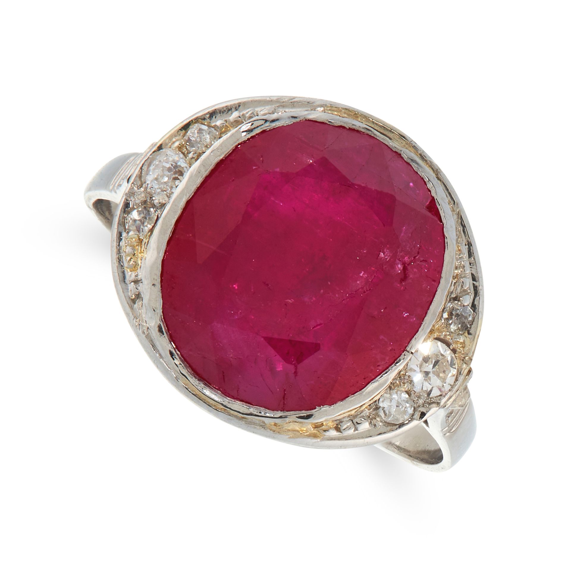 A BURMA NO HEAT RUBY AND DIAMOND DRESS RING set with an oval cut ruby of 6.21 carats within a border