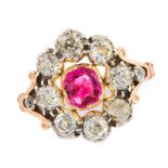 AN ANTIQUE RUBY AND DIAMOND DRESS RING in high carat yellow gold and silver, set with a cushion
