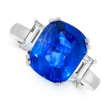 A SAPPHIRE AND DIAMOND DRESS RING set with a cushion cut blue sapphire of 5.67 carats, between two