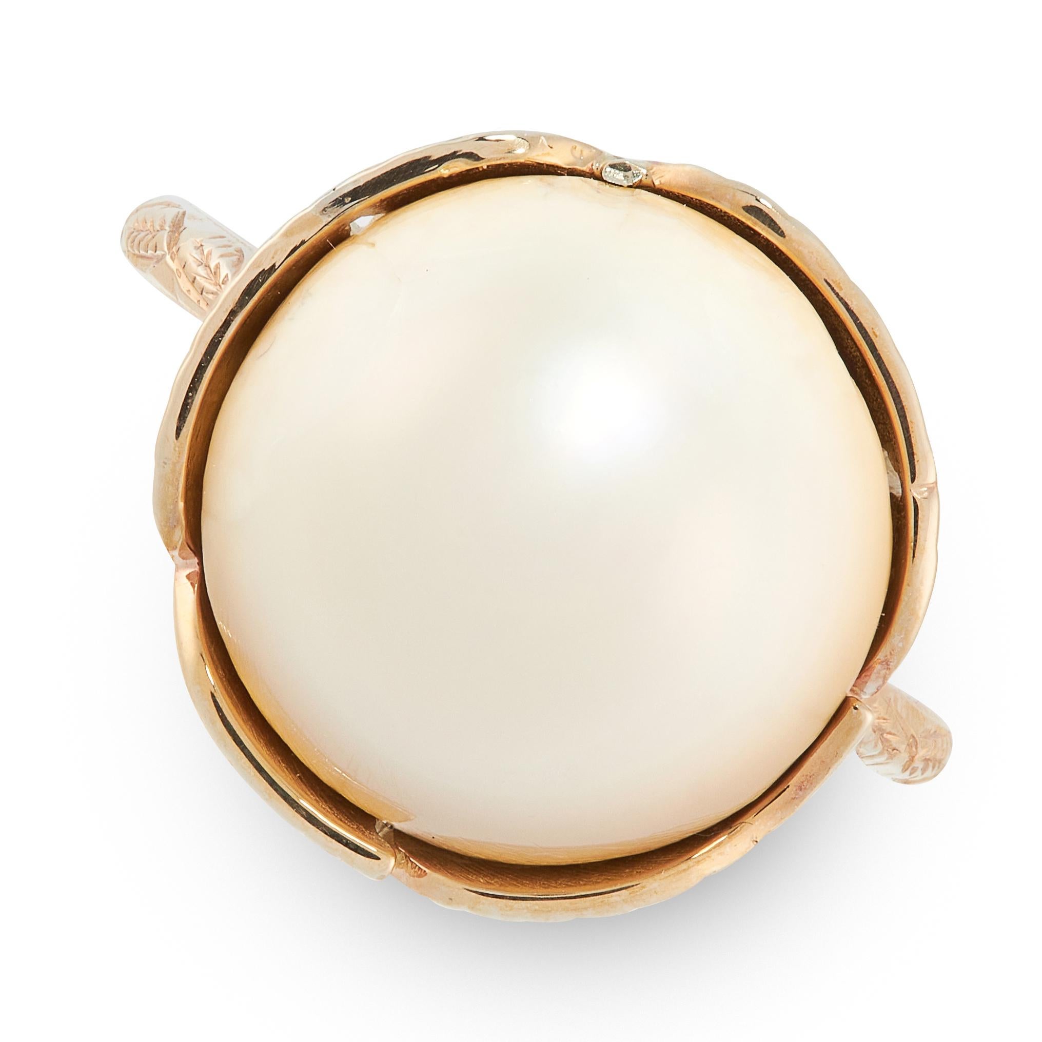 A NATURAL PEARL DRESS RING in yellow gold, set with a circular natural blister pearl of 13.81mm,