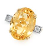 A CITRINE AND DIAMOND DRESS RING in 18ct yellow gold, set with an oval cut citrine between two round