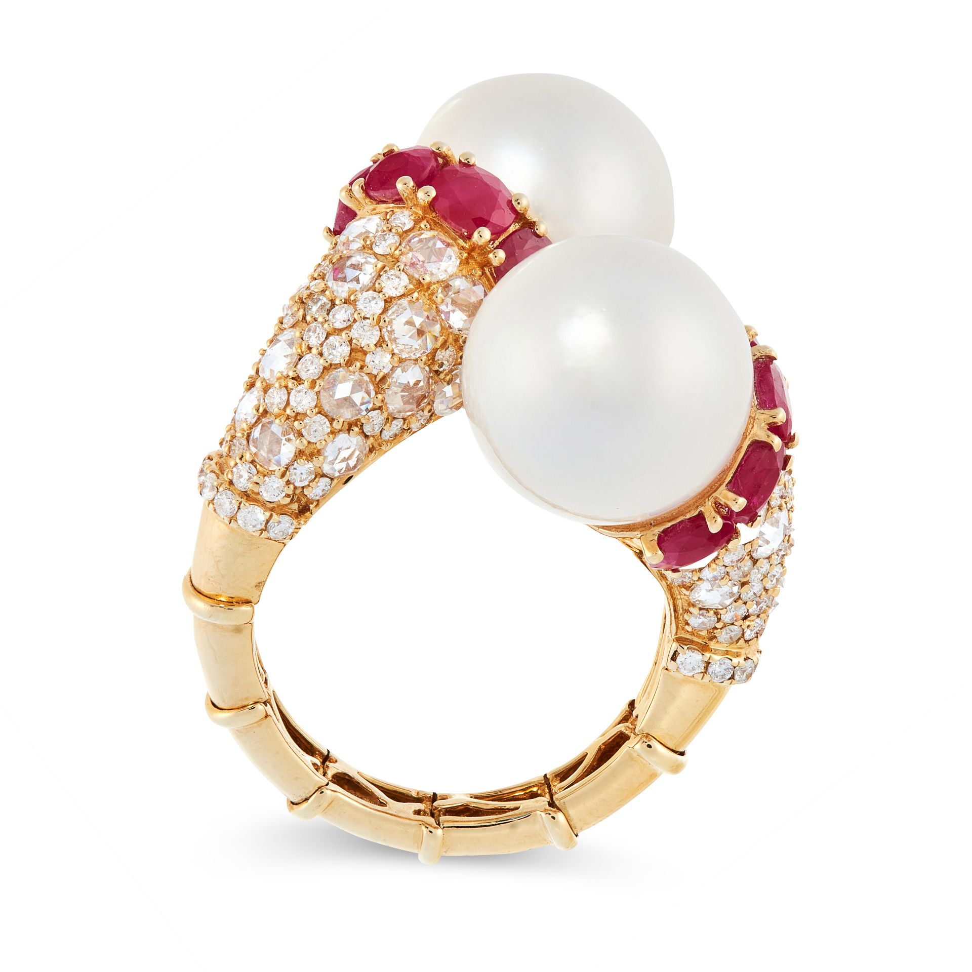 A PEARL, RUBY AND DIAMOND CROSSOVER RING each end is set with a pearl, in a border of oval cut