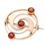 AN ABSTRACT GOLD BROOCH in 15ct yellow gold, the circular face is designed in swirling motif, set