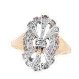 A DIAMOND DRESS RING in 18ct yellow gold, the stylised face of openwork design, set with single