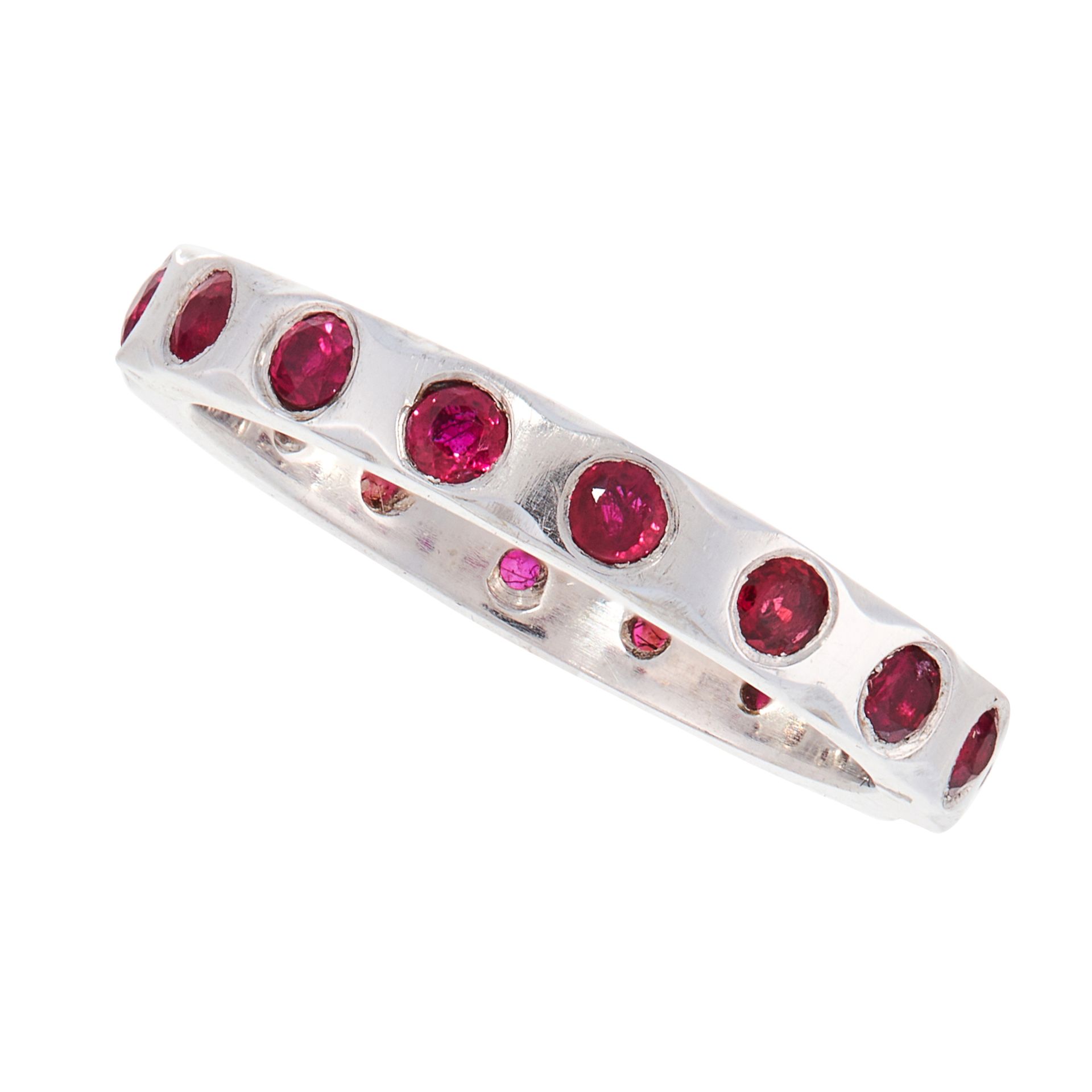 A RUBY ETERNITY BAND RING, 1938 in platinum, the stylised band set with round cut rubies, full