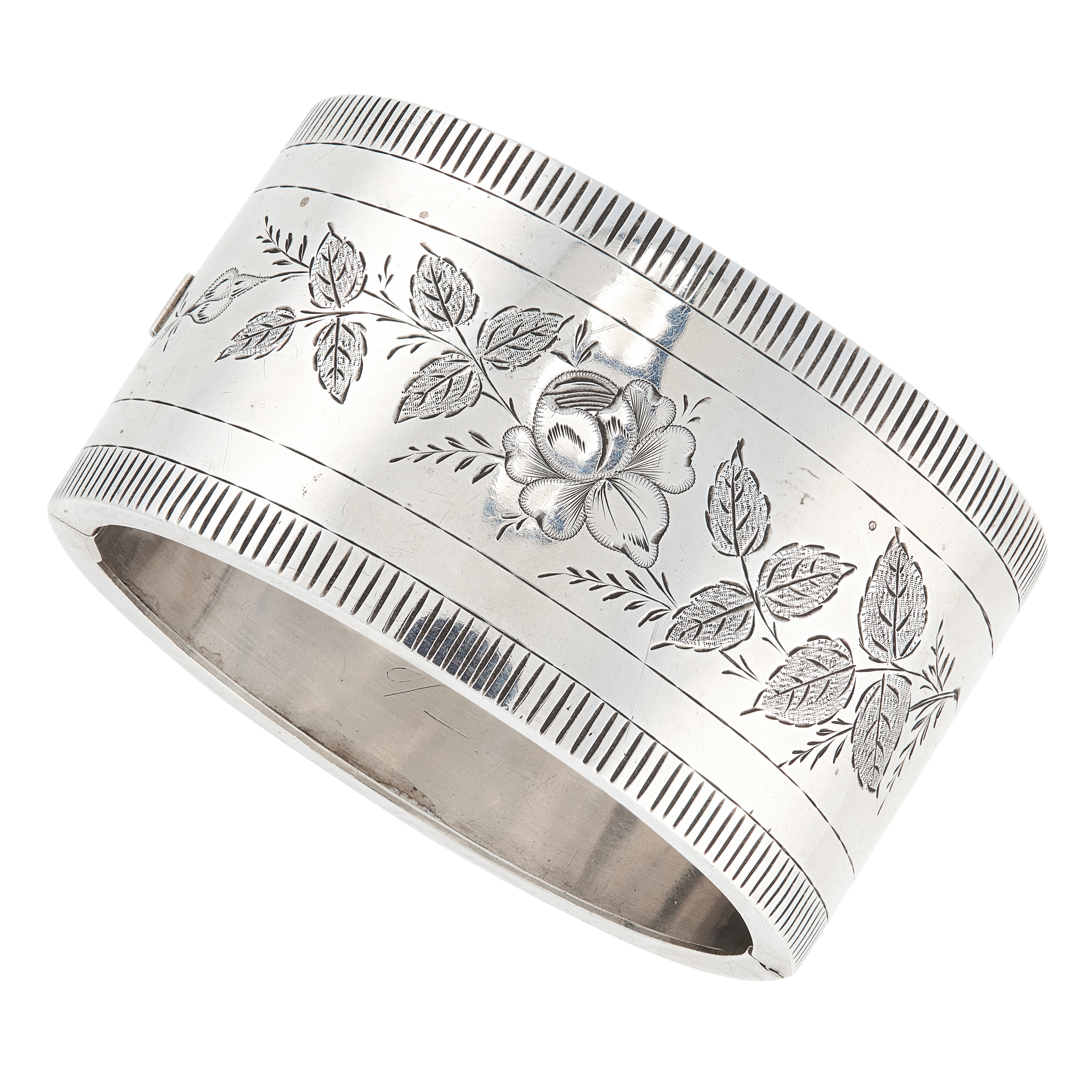 AN ANTIQUE VICTORIAN CUFF BANGLE, 1882 in sterling silver, the band with engraved foliate designs