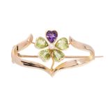 AN ANTIQUE PERIDOT, AMETHYST AND PEARL SUFFRAGETTE BROOCH, CIRCA 1900 in 15ct yellow gold,