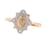 AN OPAL AND DIAMOND DRESS RING, CIRCA 1940 in 18ct yellow gold and platinum, set with an oval