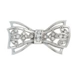 A VINTAGE DIAMOND BOW BROOCH in the form of a bow, decorated with foliate motifs set with round