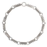 AN ANTIQUE SILVER COLLAR NECKLACE comprising of alternating decorated batons and circular links,