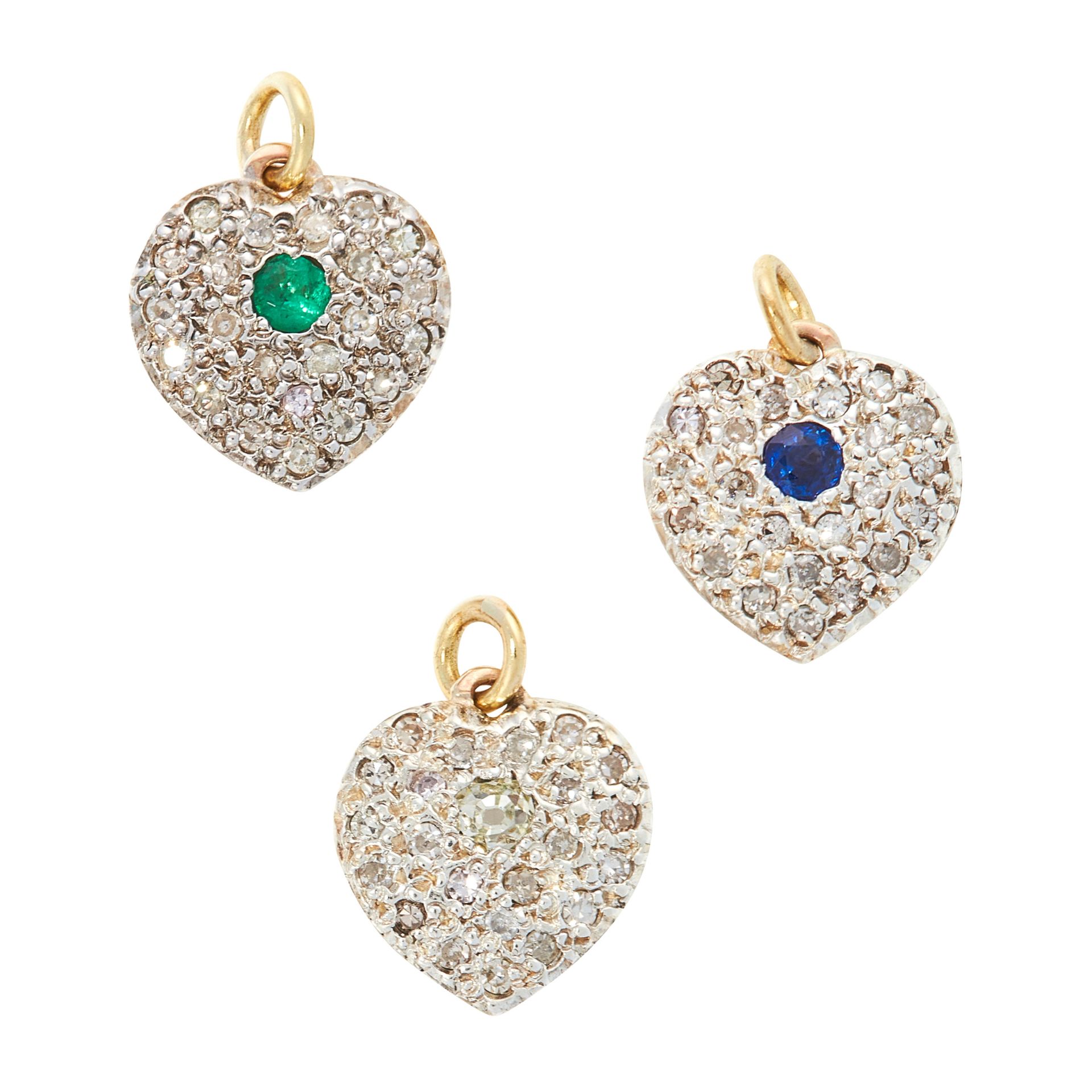THREE SAPPHIRE, EMERALD AND DIAMOND HEART CHARMS / PENDANTS in yellow gold and silver, each designed