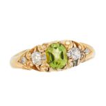 AN ANTIQUE PERIDOT AND DIAMOND DRESS RING, CIRCA 1900 in high carat yellow gold, set with an oval