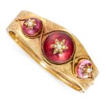 AN ANTIQUE GARNET AND PEARL BANGLE, 19TH CENTURY in yellow gold, the tapering body set with a trio