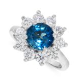 A SAPPHIRE AND DIAMOND CLUSTER RING in platinum, set with a round cut sapphire of 2.30 carats in a