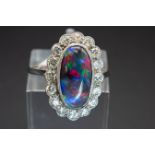 A PLATINUM, BLACK OPAL AND DIAMOND RING