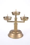 A BRASS PRICKET STICK, with three circular candle stands, bears engraved Nazi SS