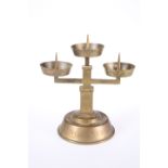 A BRASS PRICKET STICK, with three circular candle stands, bears engraved Nazi SS