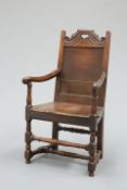 AN EARLY 18TH CENTURY OAK PANEL-BACK WAINSCOT CHAIR