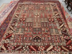 A BAKHTIAR CARPET, the centre with a grid-like design of forty squares