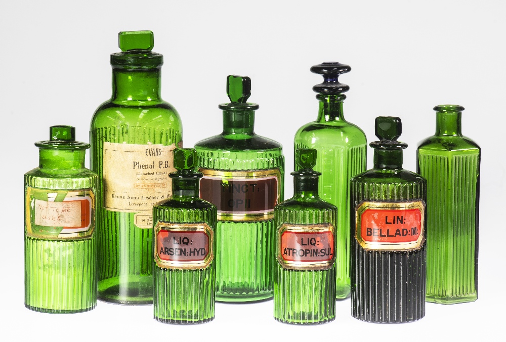 A GROUP OF EIGHT LATE VICTORIAN GREEN GLASS APOTHECARY BOTTLES