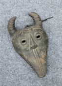 TRIBAL: A MASK, carved with horns and teeth. 30cm