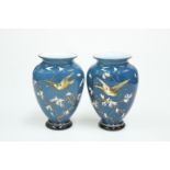 A PAIR OF VICTORIAN ENAMEL PAINTED BLUE CASED GLASS VASES