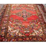 A MALAYER CARPET, the central medallion picked out in bright colours