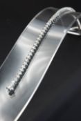 AN 18CT WHITE GOLD AND DIAMOND LINE BRACELET