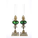 A PAIR OF LATE VICTORIAN BRASS AND GREEN GLASS OIL LAMPS