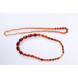 TWO STRINGS OF AMBER COLOURED BEAD NECKLACES