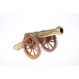 A DECORATIVE BRASS MODEL CANNON