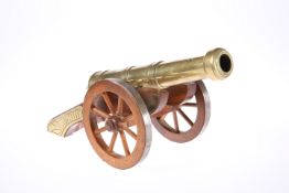 A DECORATIVE BRASS MODEL CANNON