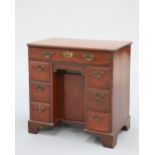 A GEORGE III MAHOGANY KNEEHOLE DESK