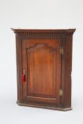 A GEORGE III OAK CORNER CUPBOARD