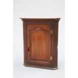 A GEORGE III OAK CORNER CUPBOARD