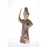 A CHINESE EARTHENWARE FIGURE