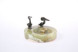 AN ONYX ASHTRAY MOUNTED WITH TWO BRONZE MODELS OF PELICANS