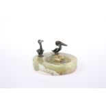 AN ONYX ASHTRAY MOUNTED WITH TWO BRONZE MODELS OF PELICANS